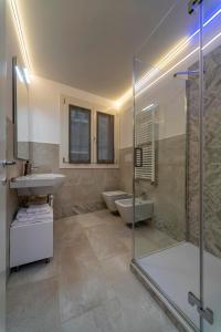 a bathroom with two sinks and a glass shower at Ca' de la Fonte - WENICE Deep Culture in Venice