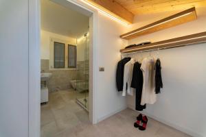 a bathroom with a walk in closet and a glass door at Ca' de la Fonte - WENICE Deep Culture in Venice +37 photos