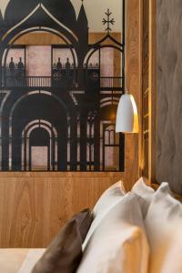 a bed with a picture of a building on the wall at Ca' de la Fonte - WENICE Deep Culture in Venice