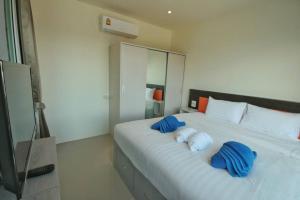 a hotel room with a bed, chair, and nightstand at Long N Joy Samui in Chaweng