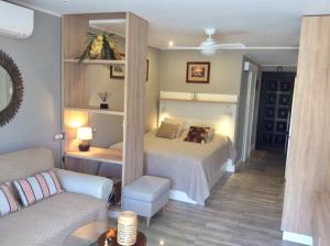 a bedroom with a large bed and a couch at Torres del Sol in Playa de las Americas +24 photos