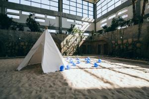 a group of blue balls in the sand in front of a building at Green Village w Aquapark Reda in Reda