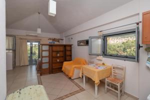 a living room with a table and a couch at Ta Spitakia Tsarbopoulos in Kyparissia