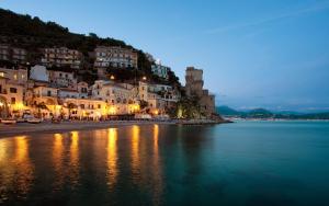 a view of a beach at night with buildings at 'A Regina b&b Cetara in Cetara