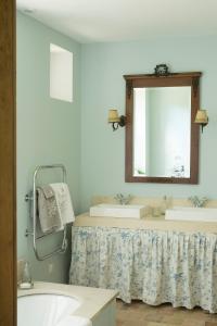 a bathroom with a sink and a mirror at La Clairière de la reine Hortense - Pierres d'Histoire in Saint-Prix