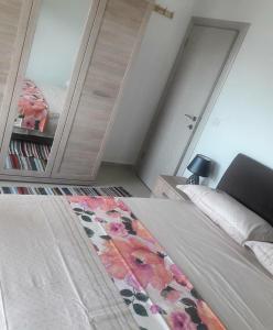 Dormitorio con cama con alfombra estampada de flores en Topla, en Herceg-Novi
