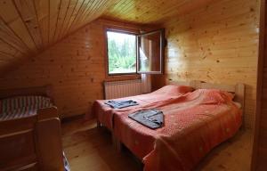 a bedroom with a bed in a wooden cabin at Mountain Family House Zara in Žabljak