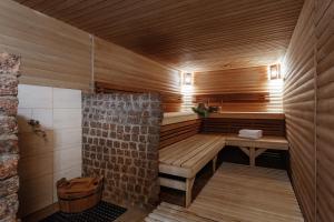 a sauna with a wooden bench in a room at Boutique Hotel California in Odesa +66 photos