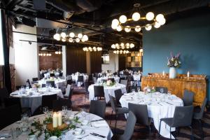 a banquet hall with white tables and chairs and chandeliers at Avon Gorge by Hotel du Vin in Bristol