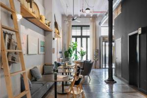a living room with a couch and a table and chairs at Hotel Brummell in Barcelona