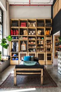 a room with a bench and a closet with shoes at Hotel Brummell in Barcelona
