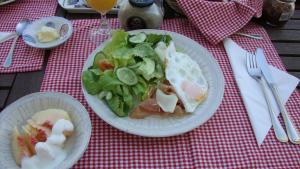 a table with two plates of food and a salad at Galleria Ars Apua in Carrara