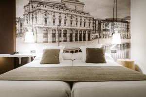 A bed or beds in a room at Hotel Abando