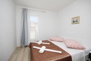 Posteľ alebo postele v izbe v ubytovaní Apartmani Lovre