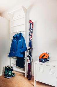 a shelf with a jacket and skis and a helmet at Hotel Kittilä in Kittilä +14 photos