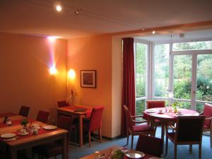 a restaurant with tables and chairs and a large window at AngerResidenz in Zwiesel
