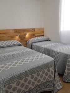 Ένα ή περισσότερα κρεβάτια σε δωμάτιο στο A un paso del mar La Mata