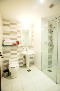 a bathroom with a toilet and a sink and a shower at Incheon Airport Hotel Zeumes in Incheon