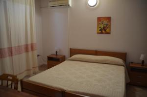 a bedroom with a bed and a table and a window at Agriturismo Agrifoglio in San Giovanni Suergiu +33 photos