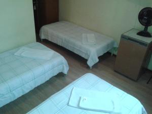 Postel nebo postele na pokoji v ubytování Hara Palace Hotel