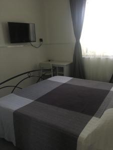 a bedroom with a bed and a television at Aeroporto Bellini Rooms in Catania