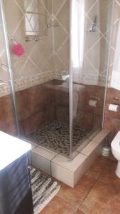 a shower stall in a bathroom with a toilet at Tehilah in Sabie +45 photos