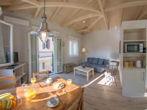 a living room with a table and a couch at Panmare City House in Lefkada