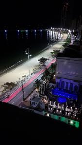 a view of a beach at night with lights at Novo lar Camboriu Park in Balneário Camboriú