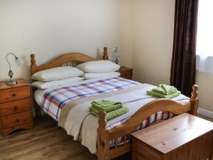 Killary Bay View House في رينفيلي: غرفة نوم عليها سرير وفوط خضراء