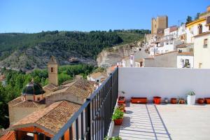 a view of a town from the balcony of a building at Alojamiento Buena Vista in Alcalá del Júcar