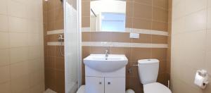 a bathroom with a toilet and a sink at Soleil Resort & SPA in Rewal