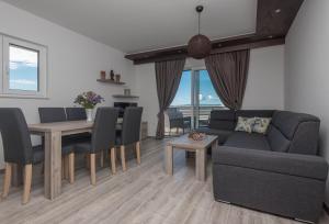 a living room with a couch and a table at Holiday Home Ivan in Makarska