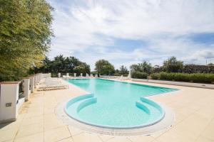 a swimming pool with lounge chairs around it at White Sand Residence in Murta Maria