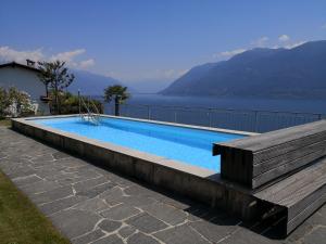 a swimming pool with a view of the water at Brilago 1 in Brissago