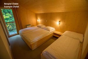 A bed or beds in a room at Alpendorf Dachstein West by ALPS RESORTS