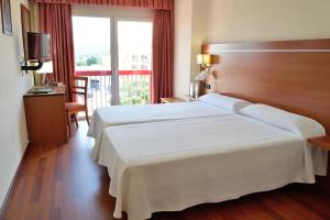 Postel nebo postele na pokoji v ubytování Hotel Mari Carmen