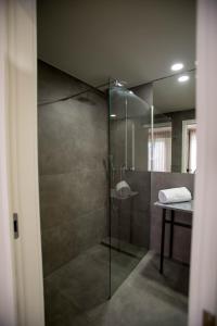 a bathroom with a shower with a glass door at The Gate in Porto