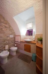 a bathroom with a toilet and a sink at La Casa del Comandante in Sulzano +102 photos