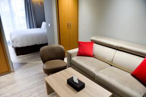 a living room with a couch and a bed at Le 22 Appart'Hotel in Casablanca +46 photos