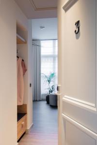 a person standing in a room with a door open at Boutique Hotel Catshuis in Leeuwarden