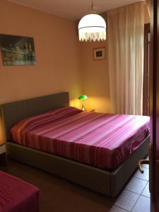 A bed or beds in a room at La ginestra Chia B&B