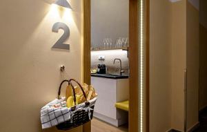 a door with a basket of bananas in a kitchen at Karoly Corner Residences in Budapest