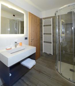 a bathroom with a sink and a shower at Hotel Stella in Passo del Tonale