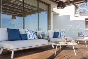 a living room with two couches and a table at Palmares Beach House Hotel - Adults Only in Lagos