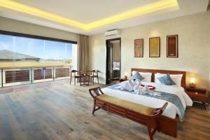 a bedroom with a large bed and a balcony at The Miracle Villa Nusa Dua in Nusa Dua +69 photos