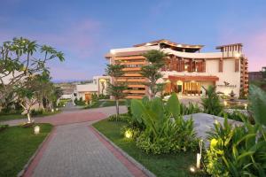 a building with a walkway in front of it at The Miracle Villa Nusa Dua in Nusa Dua
