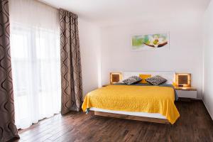 a bedroom with a bed with a yellow blanket at Villa Dora in Sužan +26 photos