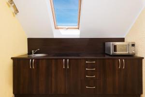 a kitchen with a microwave and a window at D.W. KRYSTYNA in Dębki