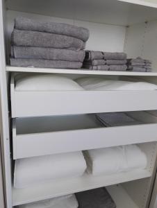 a closet filled with towels and towels at Anna Apartment in Pori