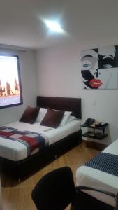Een bed of bedden in een kamer bij Hotel Quinta Avenida